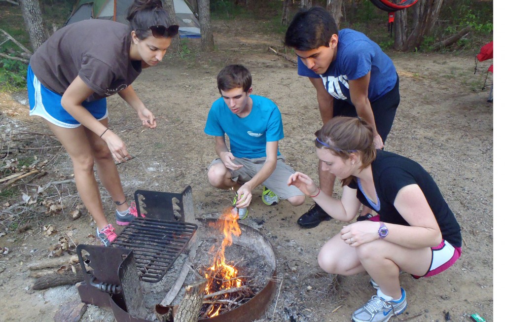 Students gather around a campfire during one of Fit & Rec's Outdoor Adventure trips. (Photo courtesty of TWU Fit & Rec)
