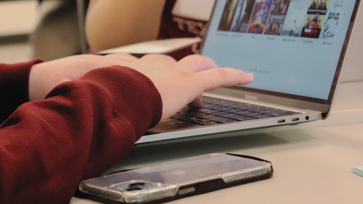 Close up view of person typing on laptop